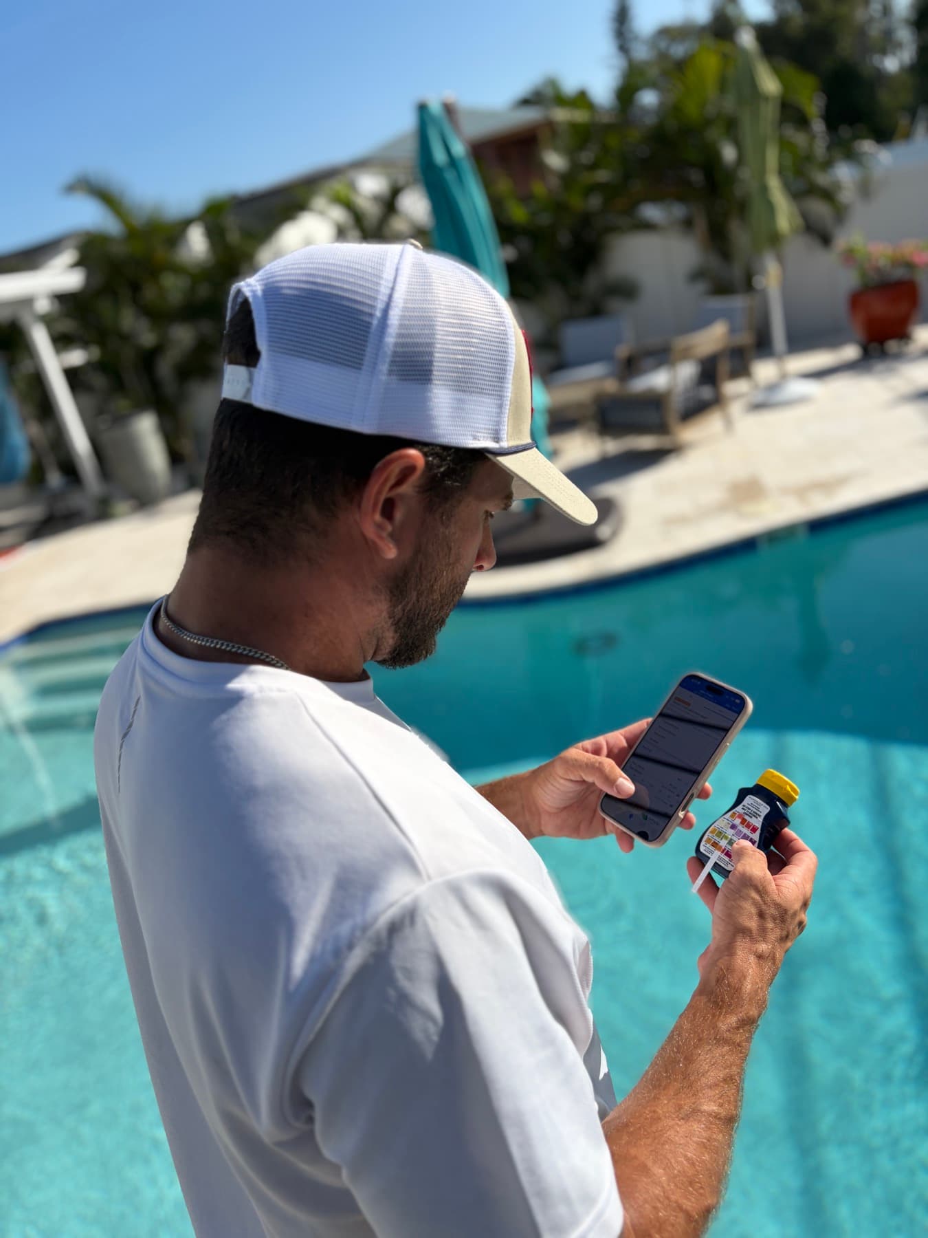 Desmond logging a pool water test result on his phone