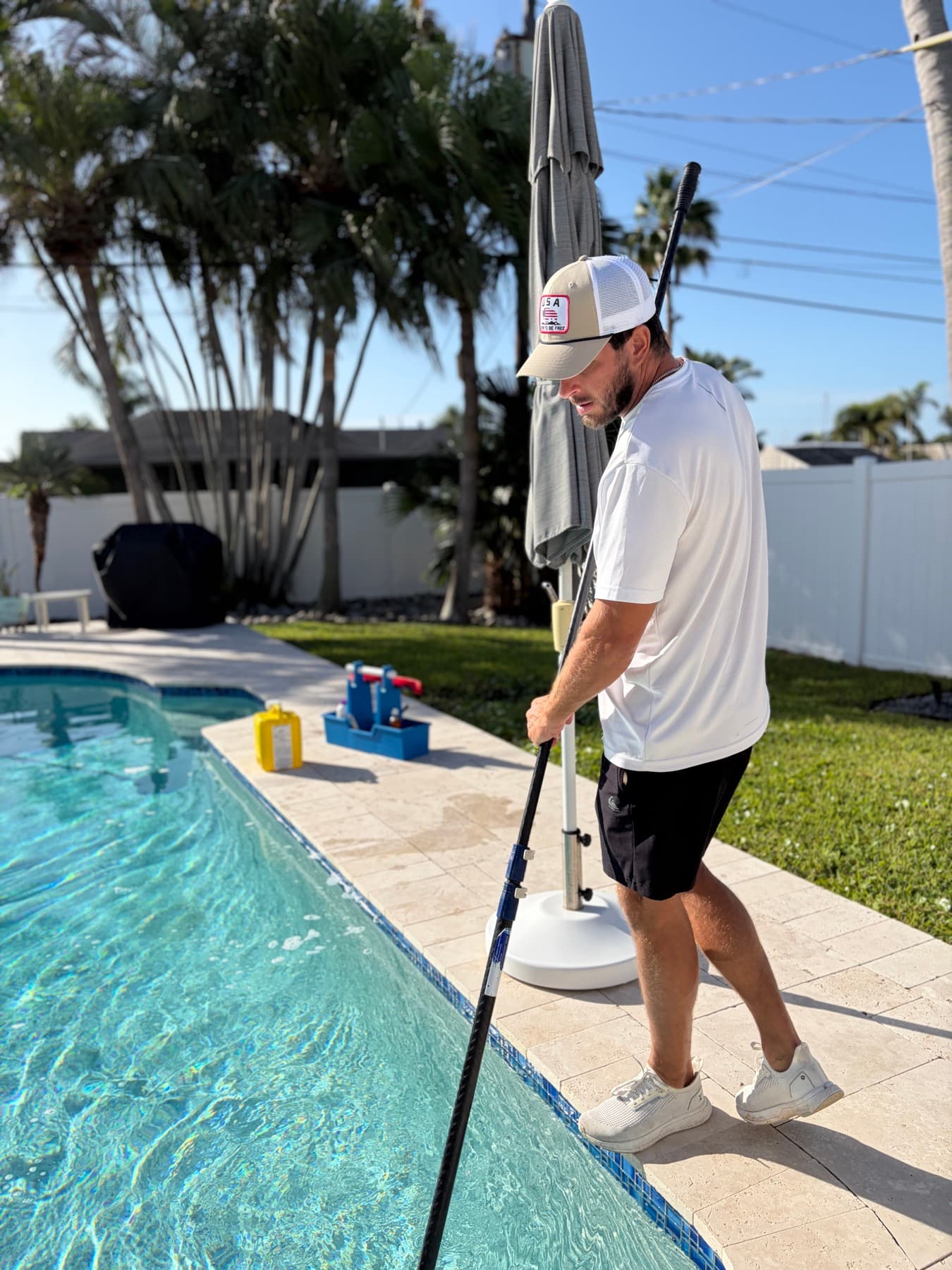 Desmond brushing the walls of a customer's pool